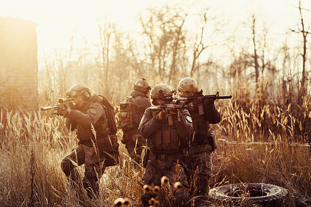 istock soldiers with guns on the field 538645707
