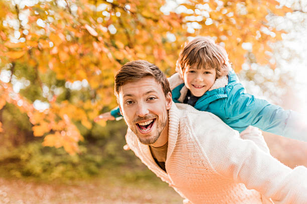 istock Father and son having fun in autumn day. 538646213
