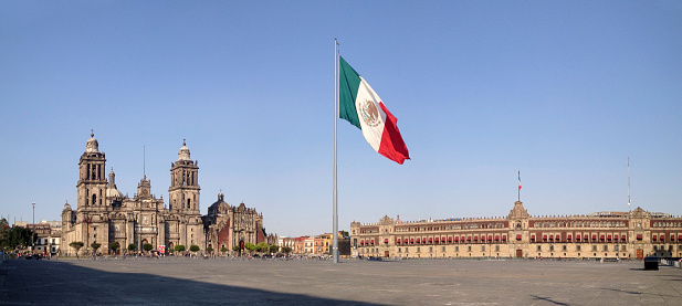 The Plaza de la Constitution, better known as Zocalo, is one of the biggest city squares in the world. It is the centre of Mexico City. To the left is the Metropolitan Cathedral (Cathedral Metropolitana), to the right National Palace, (or Palacio Nacional in Spanish), the seat of the Mexican president and the federal executive in Mexico. Shot with an iPhone.