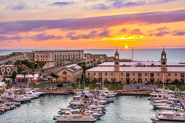 Kings Wharf Sunset Kings Wharf,Bermuda, May 25,2016: Kings Wharf at sunset with the clock towers and Casemates Prison in Bermuda.  bermuda stock pictures, royalty-free photos & images