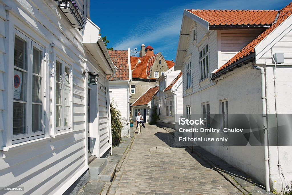 Tourist walks by the street of Stavanger, Norway. Stavanger, Norway - June 04, 2010: Unidentified tourist walks by the street of the old town on June 04, 2010 in Stavanger, Norway. Stavanger city is often called "The Oil Capital of Norway". 2015 Stock Photo
