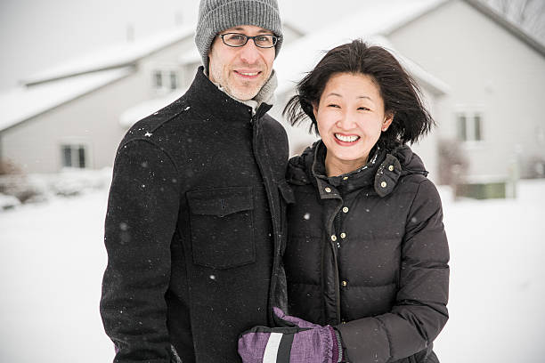 istock Multy-ethnic couple have fun outdoor under the snowfall 538650232