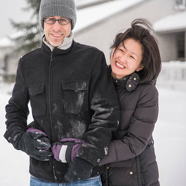 istock Multy-ethnic couple have fun outdoor under the snowfall 538650278