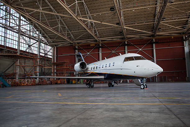 Business jet airplane stays in hangar.. Business jet airplane.. airplane hangar photos stock pictures, royalty-free photos & images