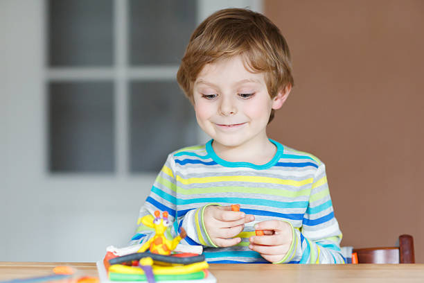 istock Happy little child, adorable creative kid boy playing with dough 538651691