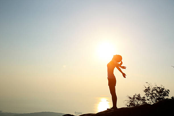 istock cheering  woman sunset seaside 538651877