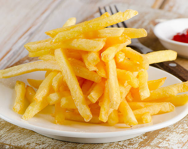 istock French fries on a wooden table 538653011