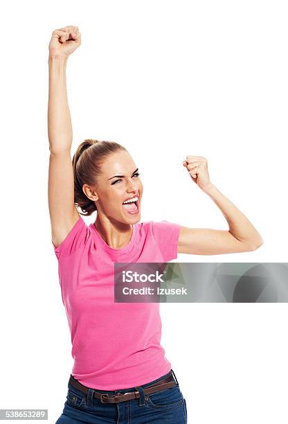 Excited Young Woman With Raised Fists Studio Portrait Stock Photo - Download Image Now