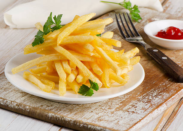 istock French fries on a wooden board 538653411