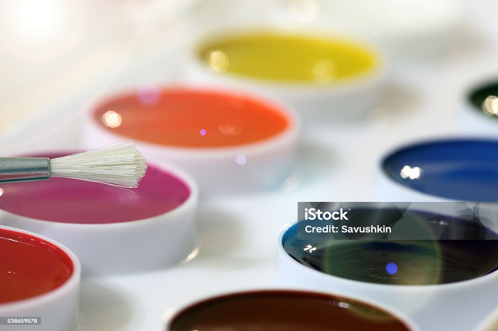 Paints Multi-colored paints and a brush. Art Stock Photo
