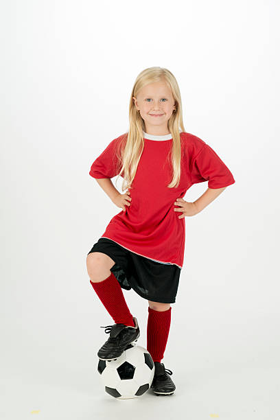 istock A elementary age girl is standing with her foot on 538664296