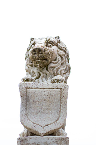 A 19th-century stone lion garden ornament against white background with plenty of copy space. Shot in Italy.