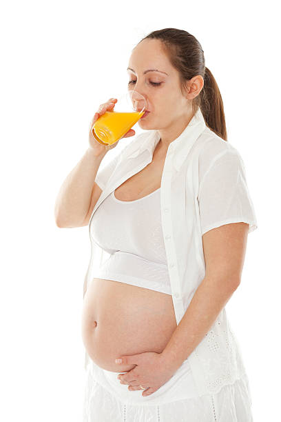istock Pregnant woman with orange juice 538667610