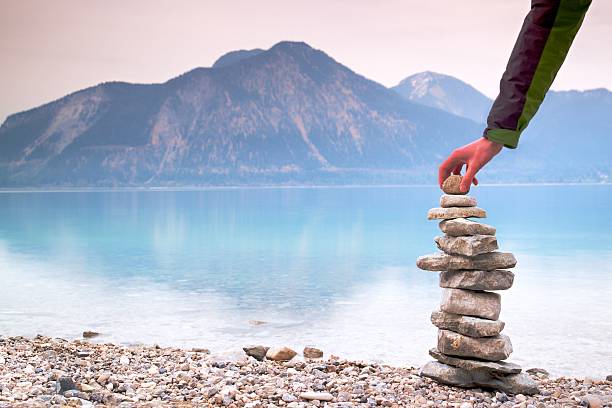 istock Man built pyramid from pebbles. Balanced stones pyramide memories 538673074