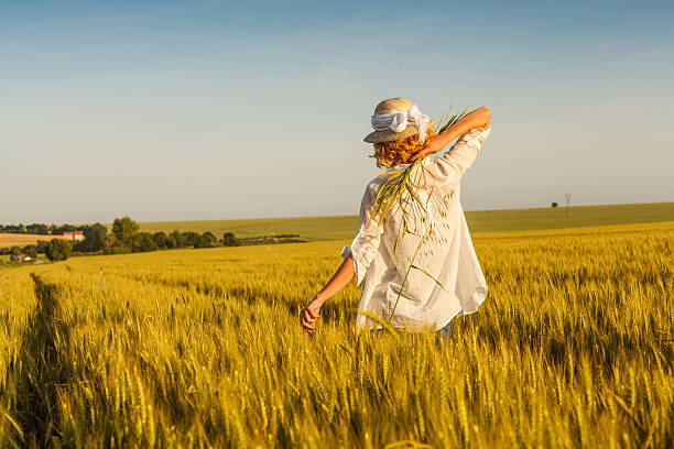istock woman in wheat filed 538673654