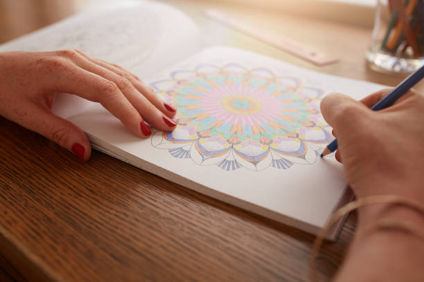 istock Female hands drawing in adult coloring book 538674524