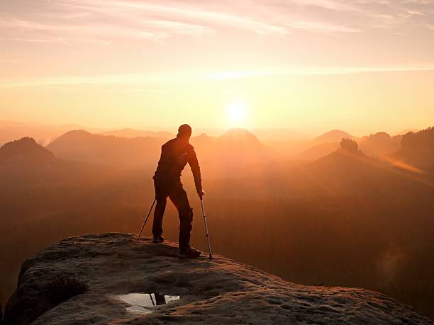 istock Bended man with medicine crutch.  Hiker with leg in immobilizer 538675968
