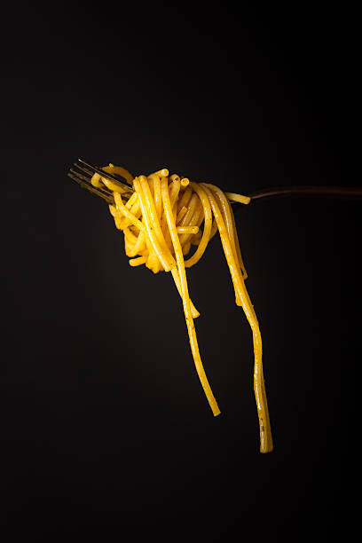 istock Fork full of spaghetti with sauce on black background 538676706
