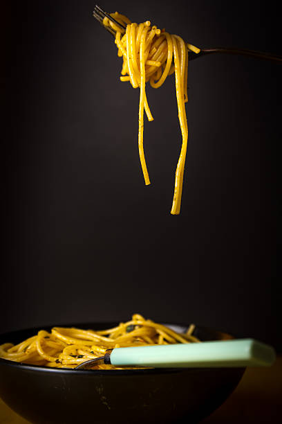 istock Fork full of spaghetti with sauce on black background 538676728