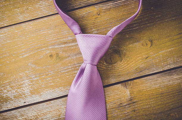 istock Elegant purple tie on wooden background 538679626