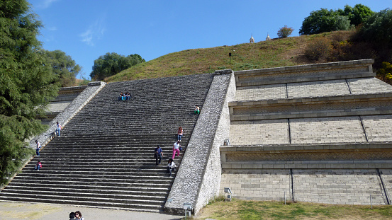Cholula, Puebla, Mexico - January 04, 2013: People at a staircase restored to its former state on one side of the Great Pyramid of Cholula complex. 