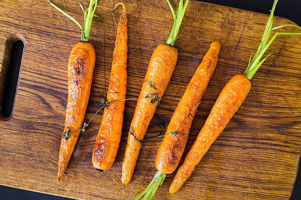 istock Roasted carrots on a black cast iron skillet 538680546