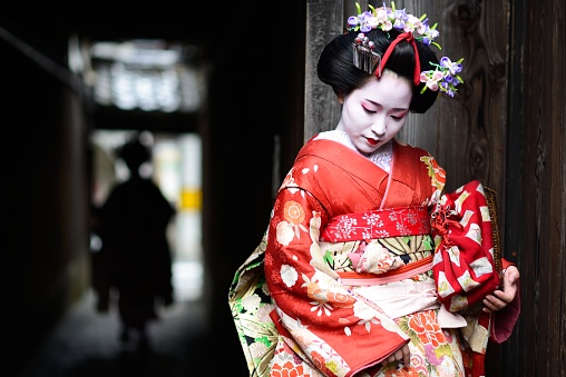 Two young maiko girls, geishas in training, in the streets of Kyoto.