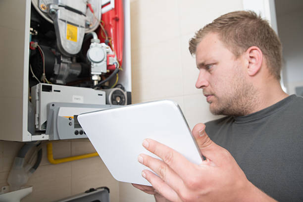 istock Technician repairing Gas Furnace using digital tablet 538682560