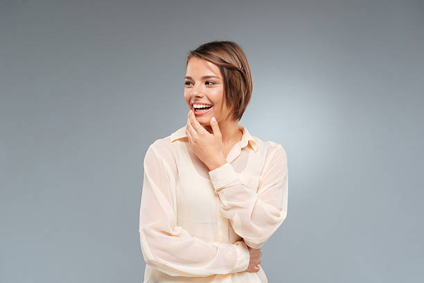 istock Laughing beautiful girl looking away over gray background 538682652