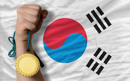 Winner holding gold medal for sport and national flag of south korea