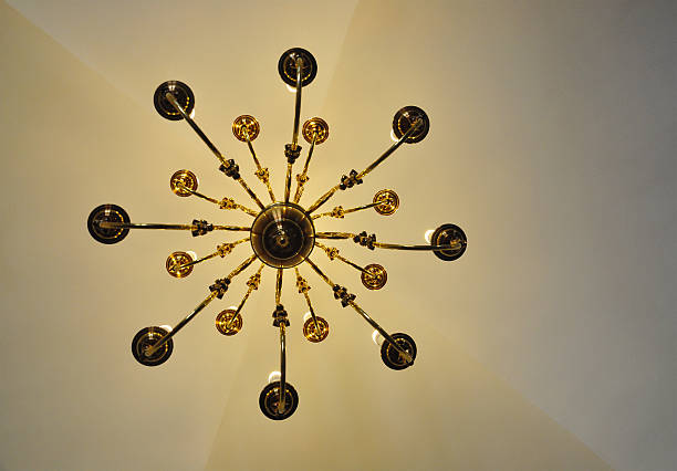 istock golden chandelier vintage, view from below, natural lights, old ceiling 538684250