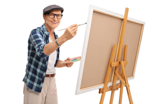 istock Joyful mature artist painting on a canvas 538684500