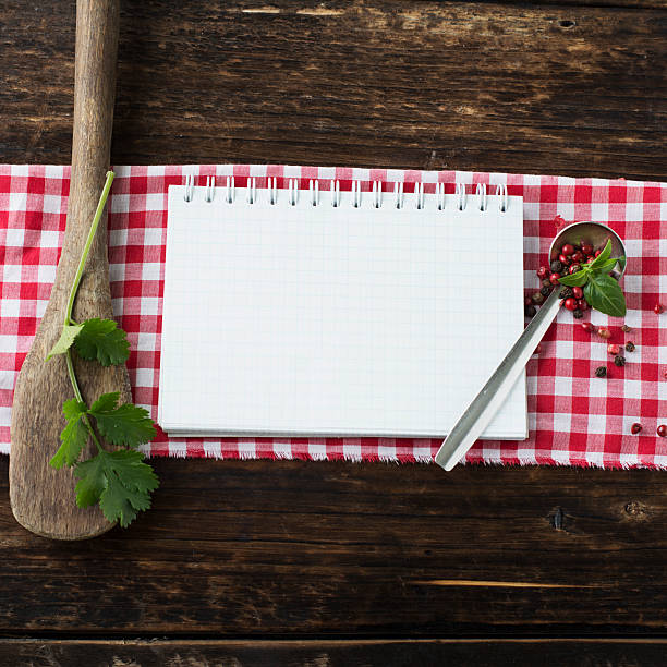 istock Open recipe book with vegetables and herbs on a wooden 538685132