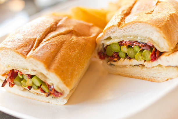 Helsinki Grilled Chicken Sandwich Nutritious Helsinki grilled chicken sandwich with asparagus and sundried tomatoes torpedo sandwich stock pictures, royalty-free photos & images