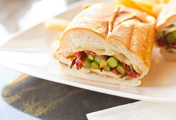 Helsinki Grilled Chicken Sandwich Nutritious Helsinki grilled chicken sandwich with asparagus and sundried tomatoes torpedo sandwich stock pictures, royalty-free photos & images