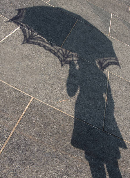 istock Shadow of a girl with parasol 538686383