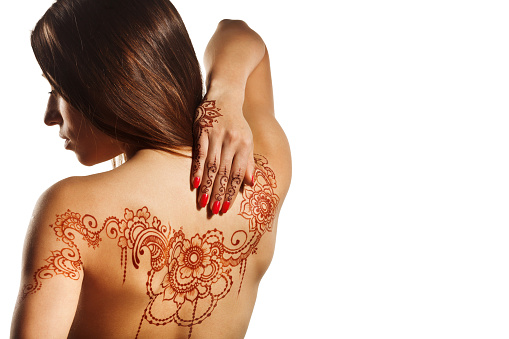 naked back of young girl with henna mehendi on white backround