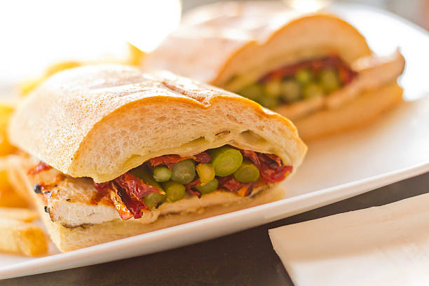 Helsinki Grilled Chicken Sandwich Nutritious Helsinki grilled chicken sandwich with asparagus and sundried tomatoes torpedo sandwich stock pictures, royalty-free photos & images