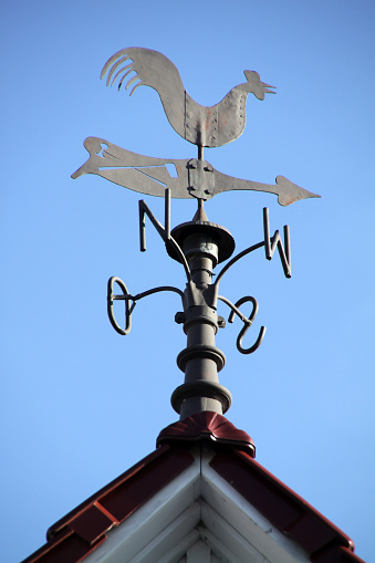Weathercock on a roof in Germany