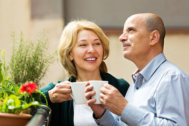 istock Mature couple on balcony with coffee 538689479