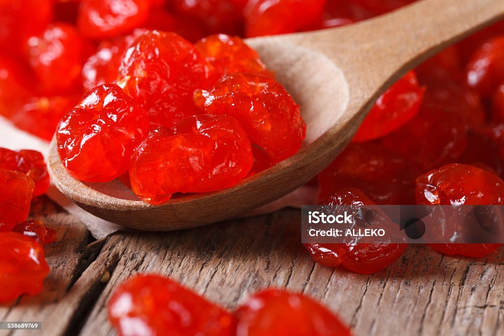 Dried red cherries in a wooden spoon,  horizontal Dried red cherries in a wooden spoon close-up. horizontal 2015 Stock Photo