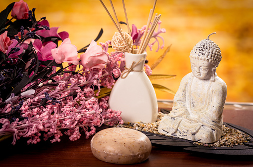 incense soaps and buddha statue with pink flowers spa concept