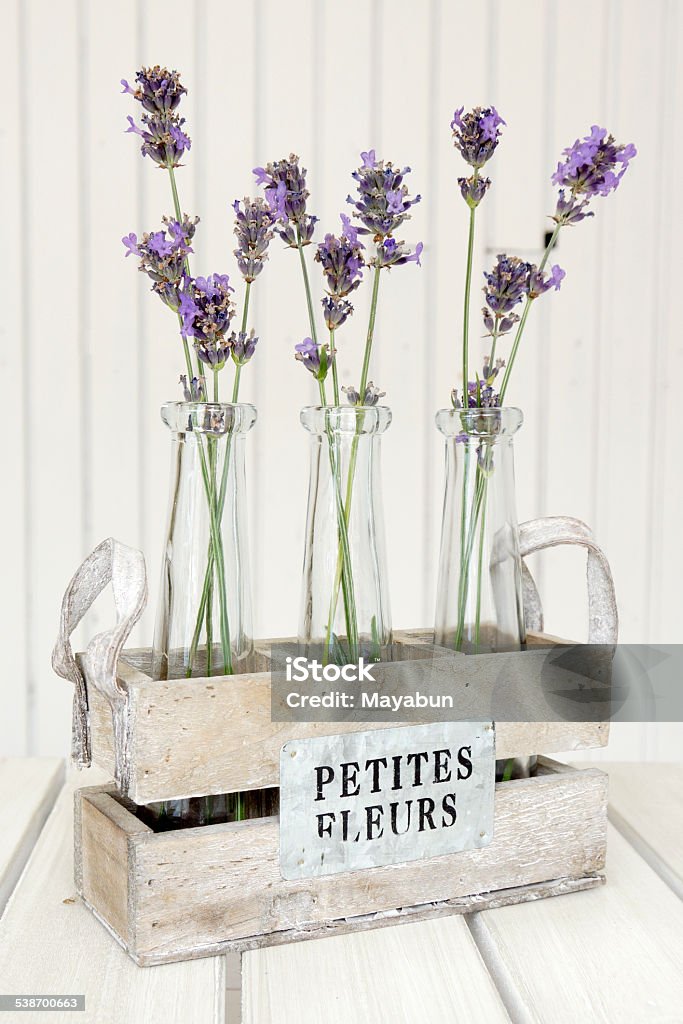 Three small vases with lavender Three small vases with lavender on a white table 2015 Stock Photo