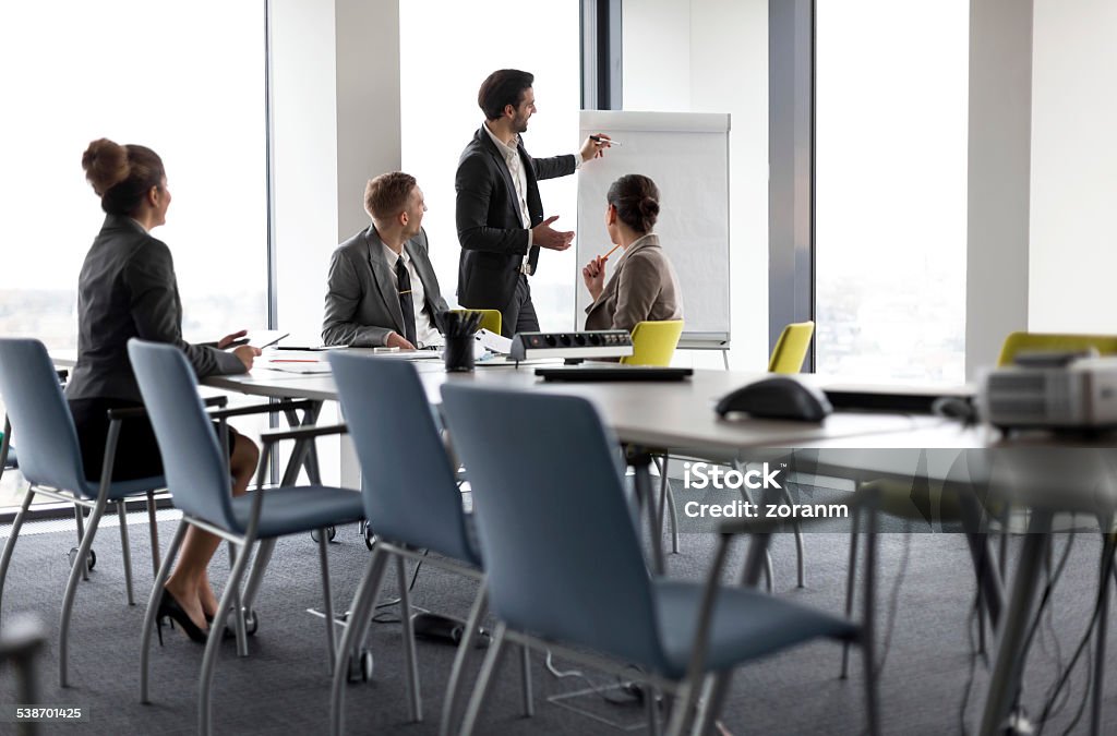 Seminar Businessman holding presentation in board room, copy space 2015 Stock Photo