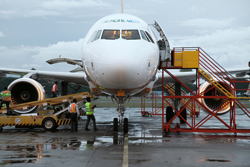 Puerto Princesa, Philippines - February 14, 2012: Workers supply plane before take-off