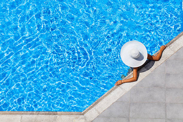 woman relaxing in resort swimming pool