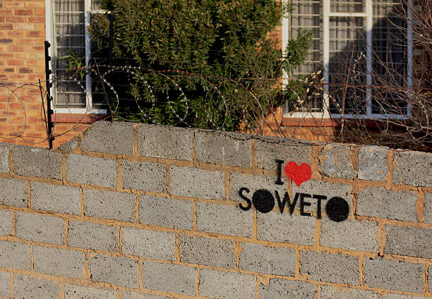 Fence with barbed wire and the inscription "I LAVE SOWETO" Fence with barbed wire and the inscription "I LAVE SOWETO" in the suburbs of Johanessburg, South Africa,   soweto stock pictures, royalty-free photos & images
