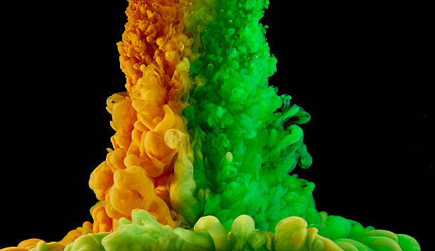 istock Green and orange ink clouds on black background 538706475