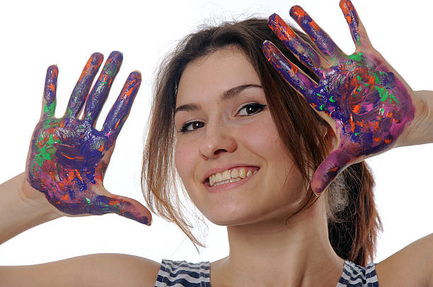 istock Girl shows her hands painted in colorful paint 538708185