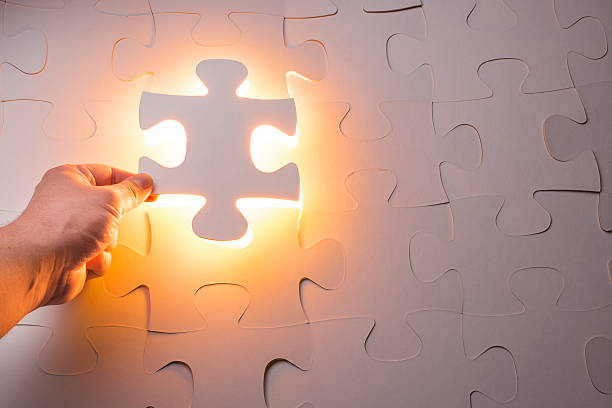 istock Hand holding the last piece of jigsaw puzzle 538708835